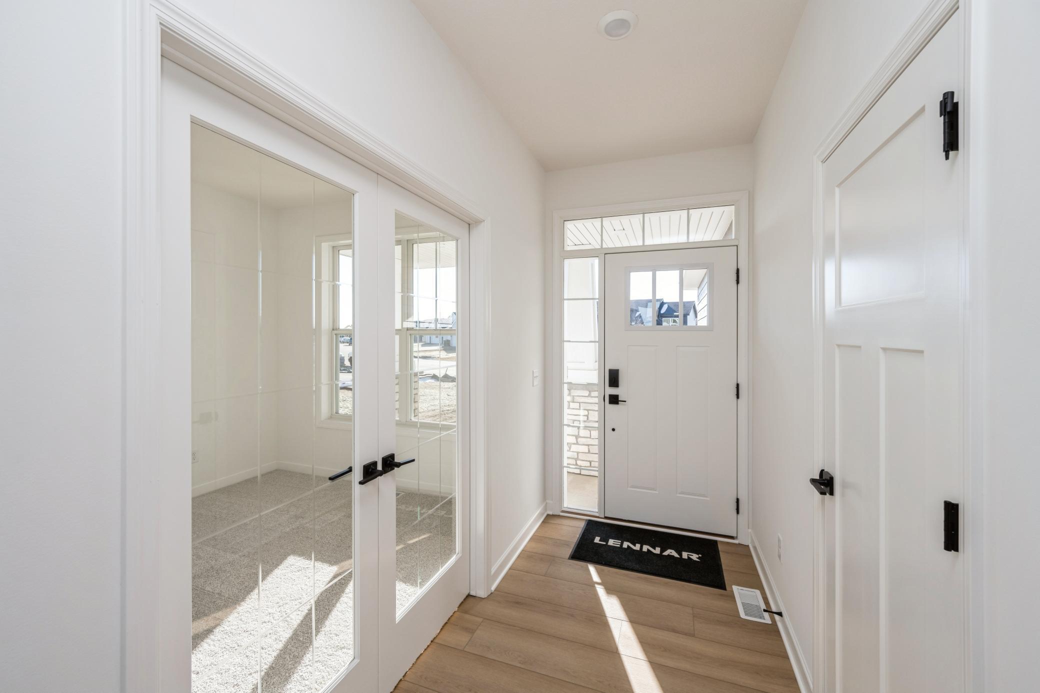 (Photo of a similar home, actual finishes may vary) The flex room has french doors