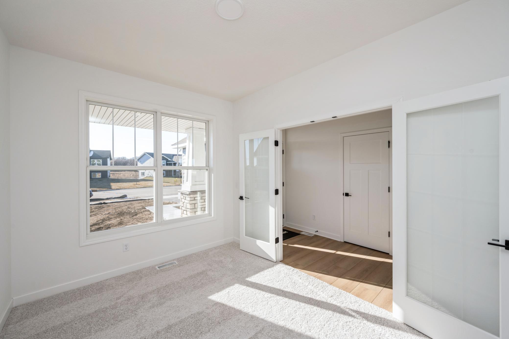 (Photo of a similar home, actual finishes may vary) The main floor flex room