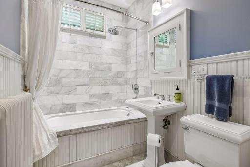 Elegant marble-clad bath combines timeless craftsmanship with modern comfort and spa-like finishes.