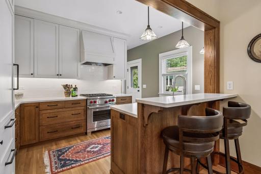 Thoughtfully renovated kitchen featuring custom cabinetry, quartz countertops, premium appliances, and abundant storage.