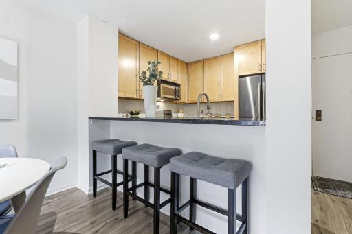 Granite breakfast bar provides additional seating and a convenient connection to the living area.