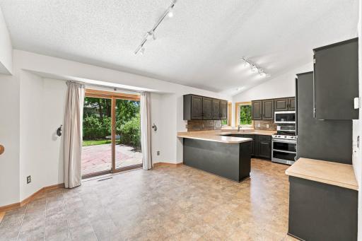 Dinning area and kitchen with a sliding glass door that leads to the back yard