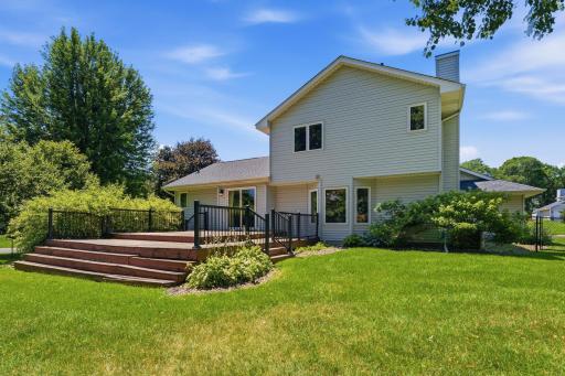 View of the back of the house and the huge deck that is just a couple steps away from the wonderful yard!