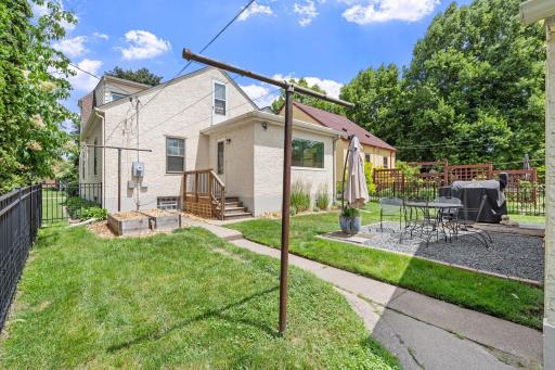 Fenced in backyard with new landscaping and raised beds