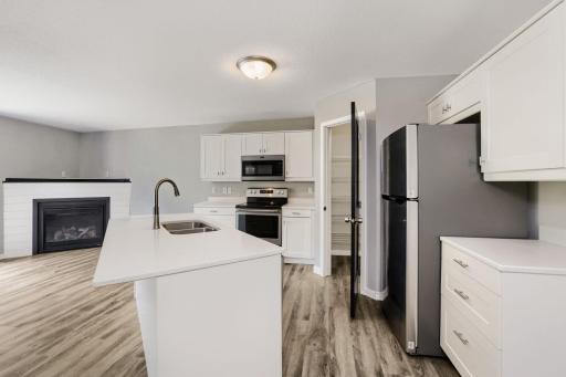 Solid surface counters, dishwasher, garbage disposal and a true pantry make this space efficient and effective to stay organized and clutter-free