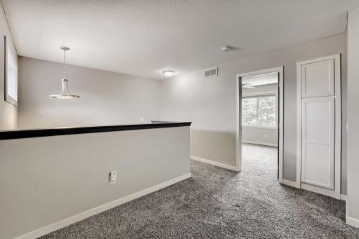 Loft with view of bedroom and linen closet