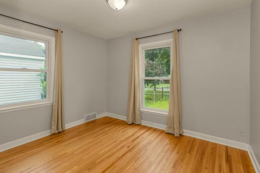 Bedroom one is on the main floor and one of three bedrooms in the home - hardwood floors, great light and those new windows!!!