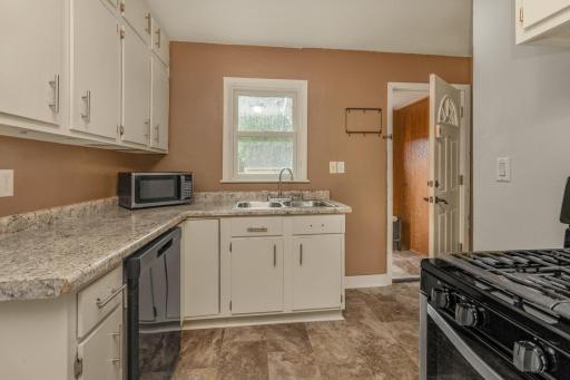 Mudroom enters into kitchen with lots of storage, newer appliances and low maintenance flooring. Dishwasher and Range (2022) and Refrigerator (2025).