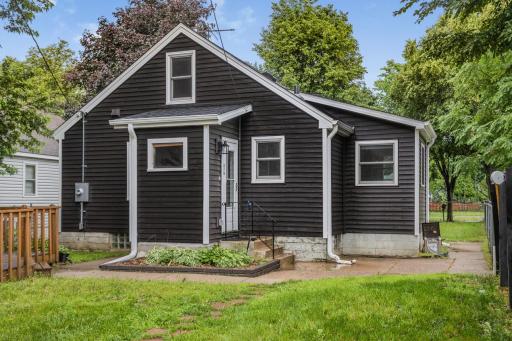 Side entry with peek at deck to the left. Yard is fully fenced and over 125 feet deep! Plenty of room for guests and those summer nights!