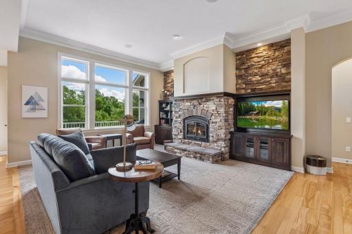 Expansive windows, rich premium grade hardwood floors (no LVP here) and dramatic floor to ceiling dry-stack stone fireplace with custom built-ins.