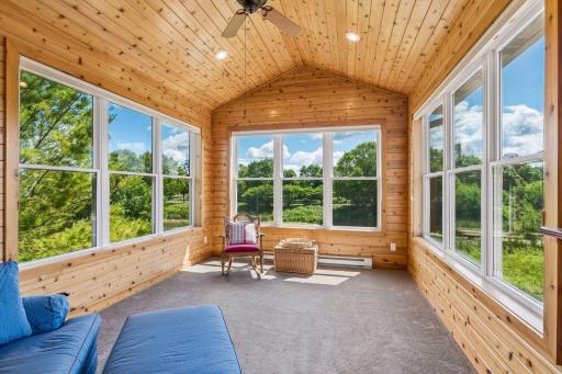 Stunning 4-season porch with vaulted knotty pine ceilings and walls, expansive windows and peaceful panoramic views. This light filled retreat is the perfect place to enjoy your mornings, read a book or unwind at the end of the day.