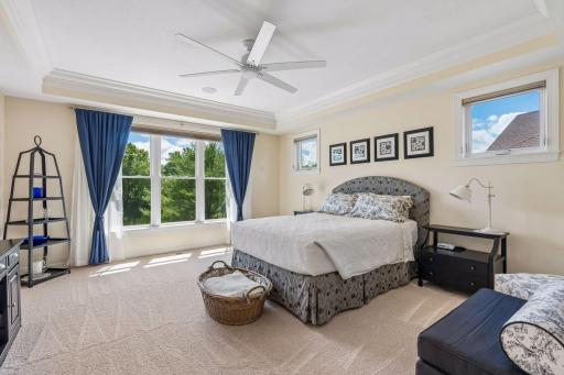 Light and fresh Primary bedroom suite: tray ceiling with crown molding, recently repainted walls along with new plush carpet.