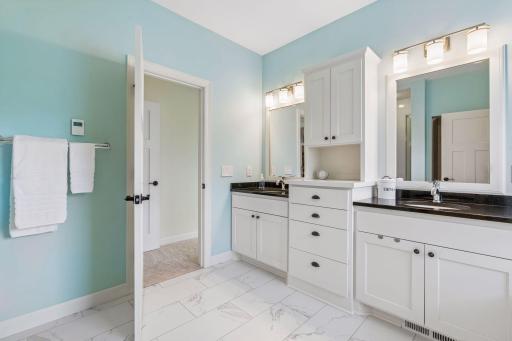 Enjoy the function and beauty of split vanities, along with the sensible and well designed storage between.