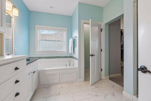 Primary ensuite with Heated tile floors, Soaking tub, private toilet room and the convenience of the walk-in closet right off the bathroom.