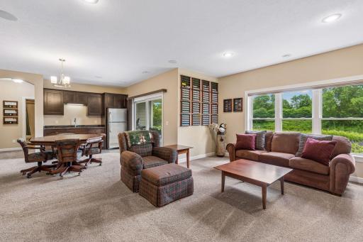 Wet bar is the perfect for effortless entertaining inside and out. Full size stainless steel refrigerator (comes in handy during the holidays too), granite countertops and slate tile floor that carries through to the patio door.