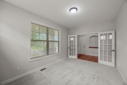 A dedicated main-level office with French glass doors provides privacy without sacrificing natural light.