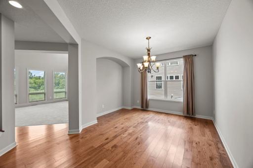 A separate formal dining room offers a more refined setting with statement lighting.