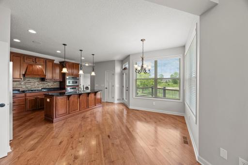 Just beyond, the informal dining area captures peaceful pond views.