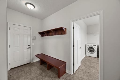It flows seamlessly into the adjacent mudroom for added convenience. Here youâll find durable tile flooring, a large walk-in closet, bench seating, and hooks.