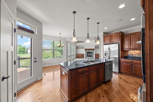 A center island with breakfast bar seating anchors the space, while a walk-in pantry offers excellent storage.