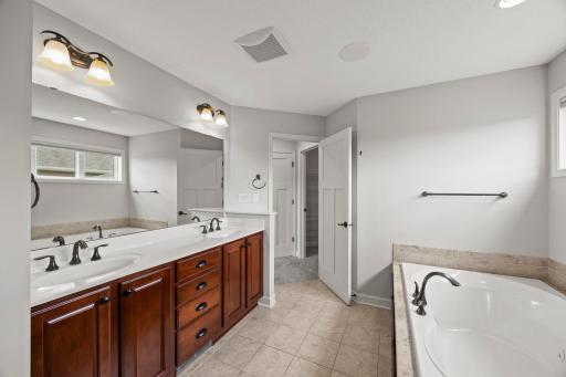 Dual vanities, and plentiful cabinetry and linen storage.