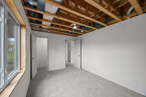 Roughed-in bathroom ready for future completion. Under-stair storage and utility room shelving add further practicality.