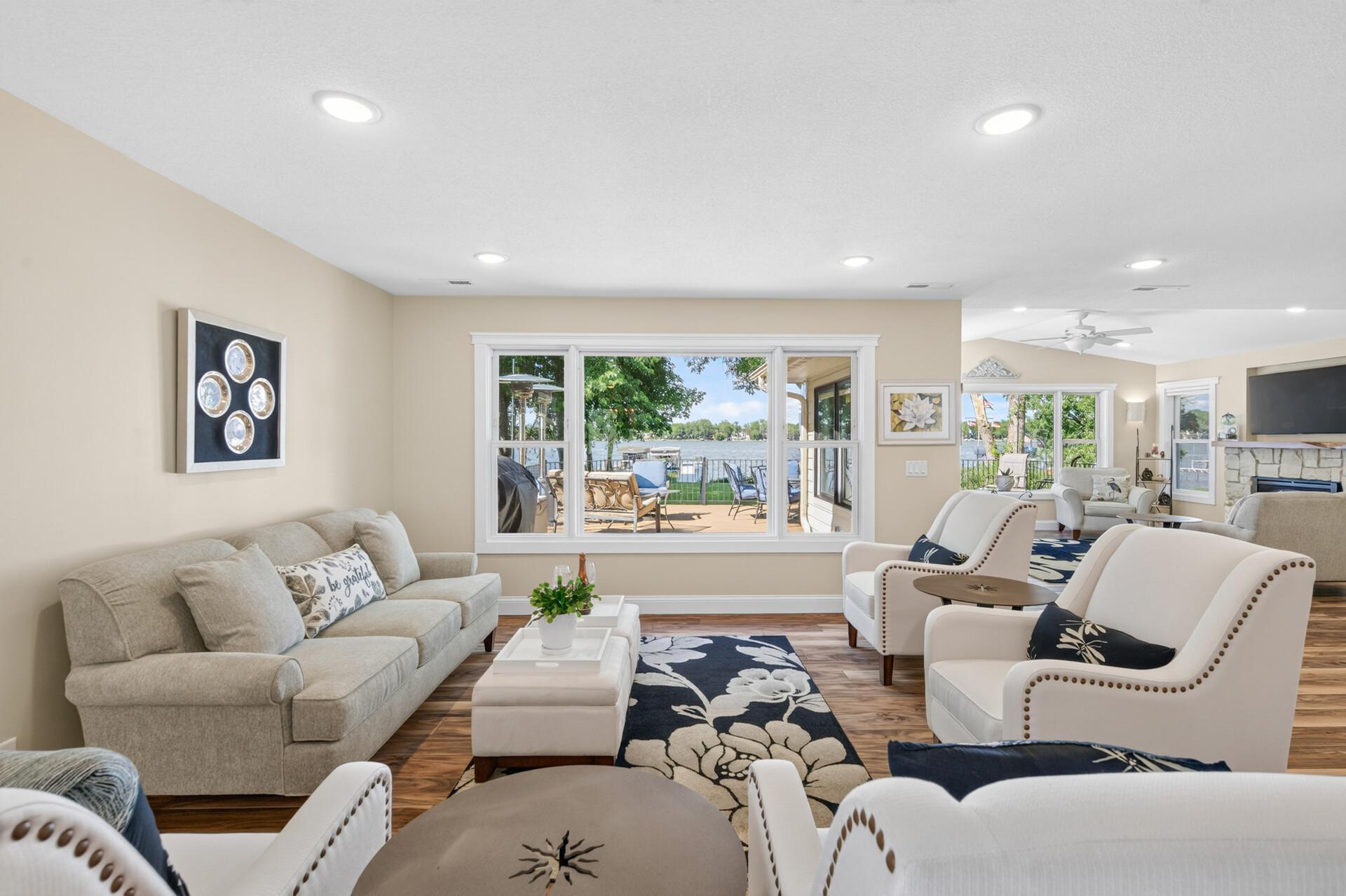 The lakeside living room offers stunning views and a bright, welcoming atmosphere.