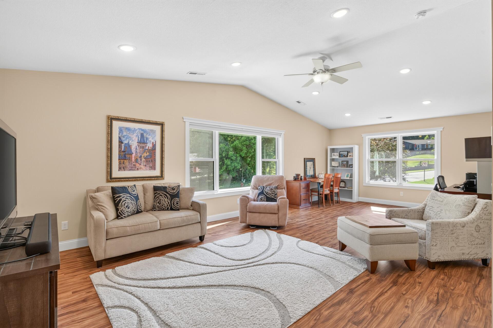 The spacious amusement room on the upper level offers flexible living space for a home office, recreation area, or entertainment area.