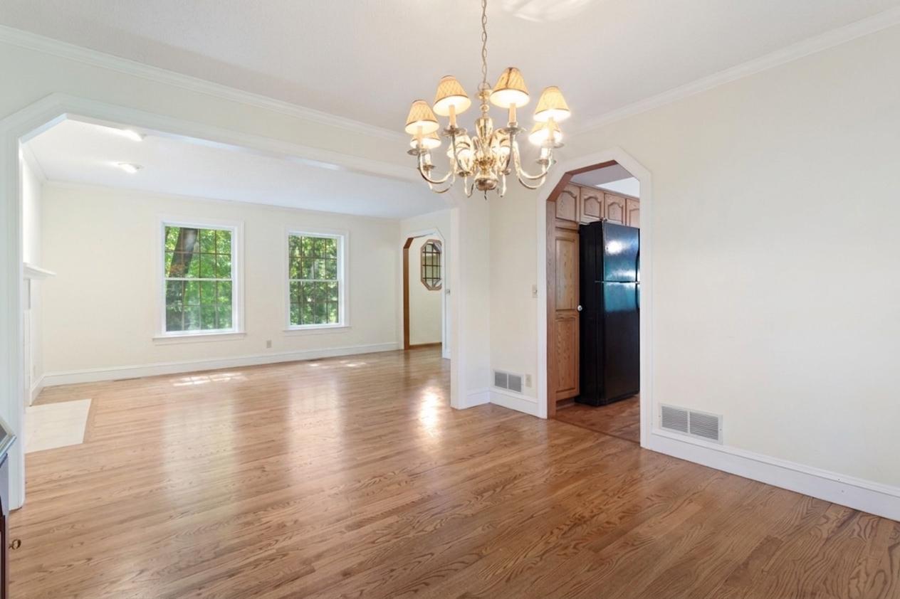 Real solid oak hardwood floors flow throughout living room, dining, & kitchen