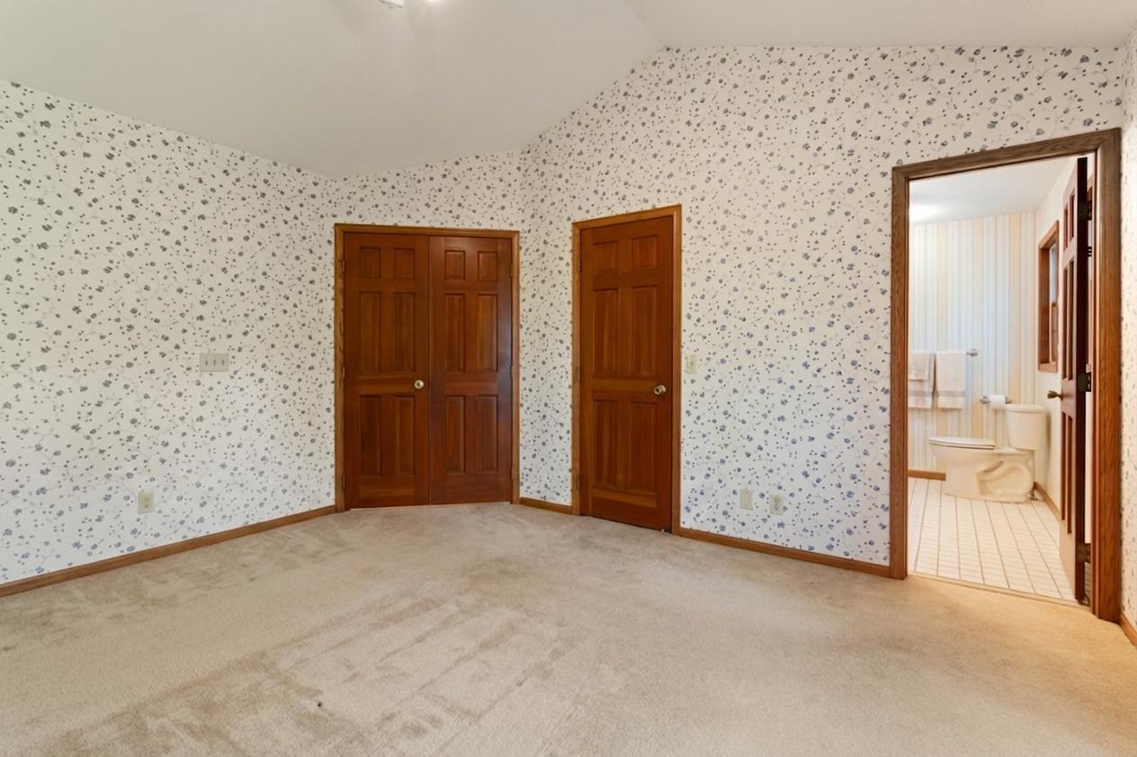 Master bedroom with double door entrance, walk-in closet and 3/4 master bath