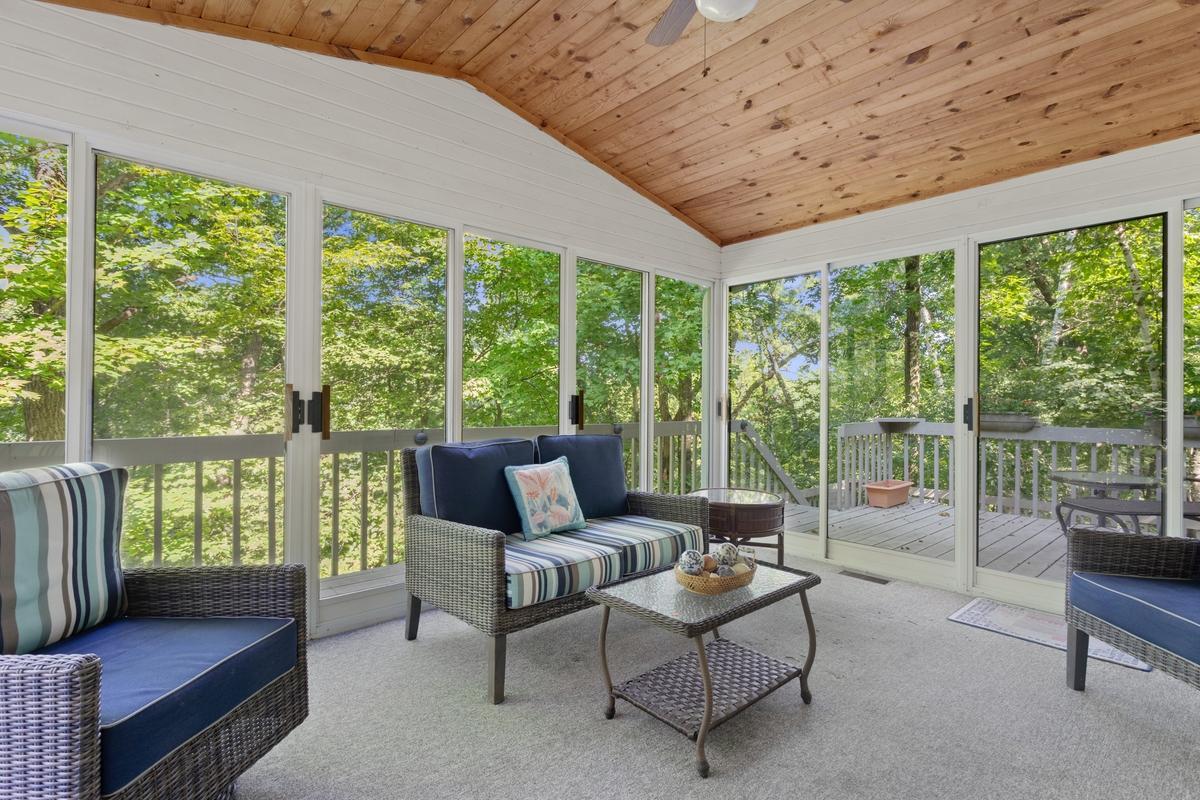 Sunroom is vaulted and overlooks wooded ravine