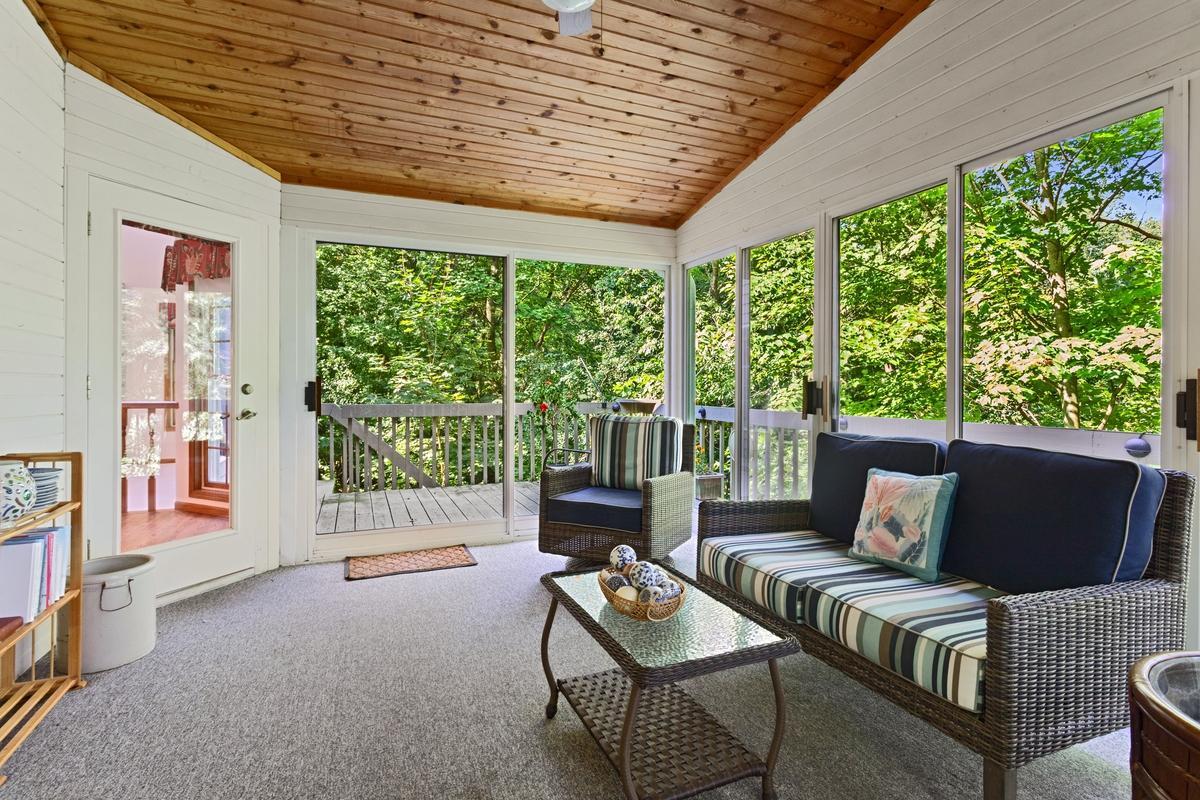 Sunroom, off kitchen and connects to wrap around deck