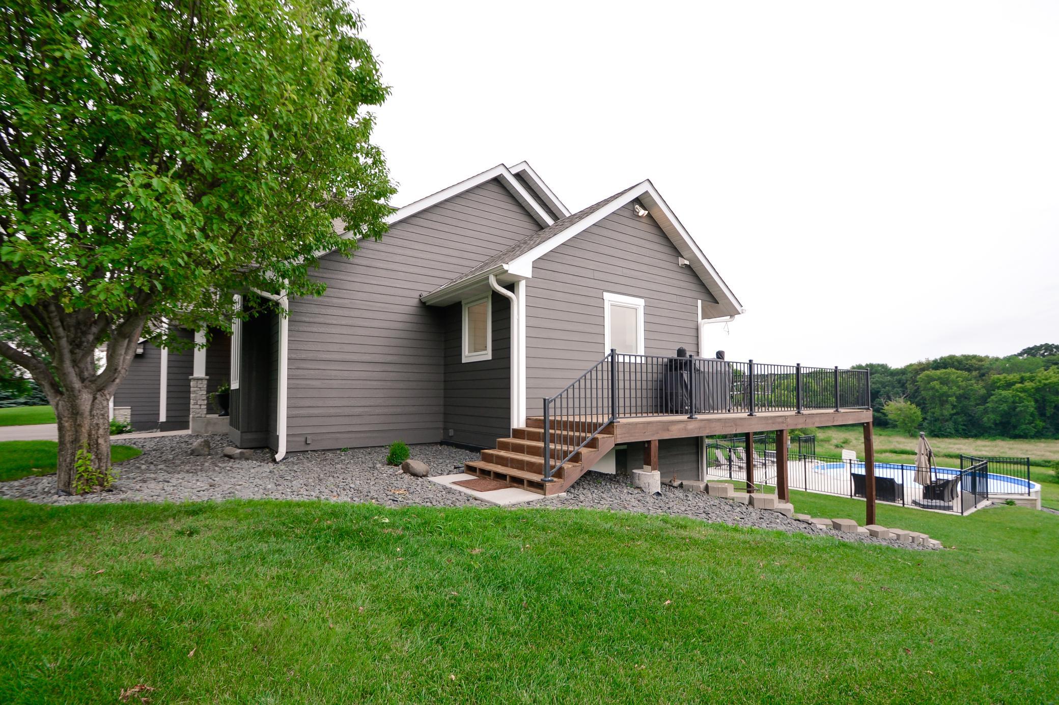 Side view of home with stairs to deck area