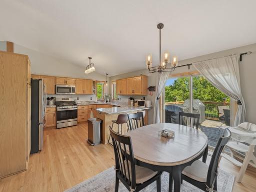 Informal dining with a light fixture and sliding glass doors to the deck!