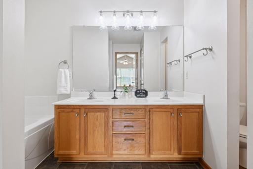 Upper bathroom features vanity with double sinks. Clean, neutral color palette throughout makes this one move in ready!