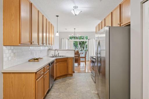 Updated kitchen w/ SS appliances, subway tiled backsplash. Abundance of kitchen cabinetry.