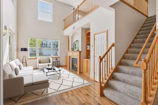 Light, bright and spacious main level. Towering ceilings w/ open loft. Custom built oak fireplace surround designed to blend with the built-in book-cases. Virtually staged so you can envision the possibilies here. Truly beautifullyl maintained townho