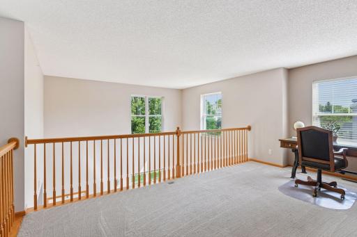 Fantastic upper loft space is a perfect flex area - great office, play area, or extra family room. Abundance of windows bring in a ton of natural light.