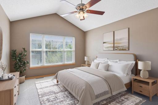 Vaulted primary suite! Sun-filled primary bedroom with large window. (Virtually staged to envision the possibilities)