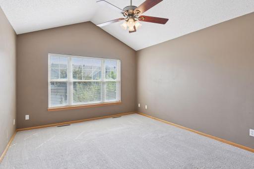 Vaulted primary suite! Sun-filled primary bedroom with large window.