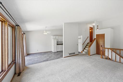 Vaulted ceilings and expansive windows create an open, airy atmosphere filled with natural light.