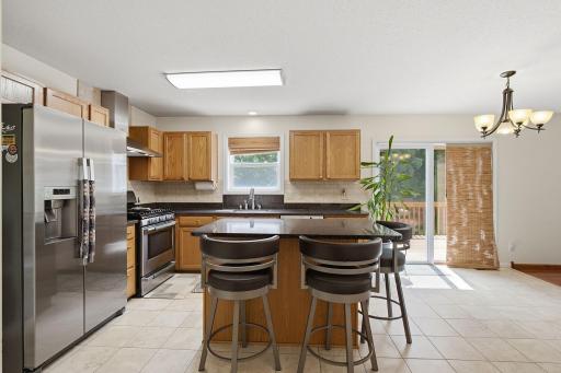 Tile floor goes under island and refrigerator.
