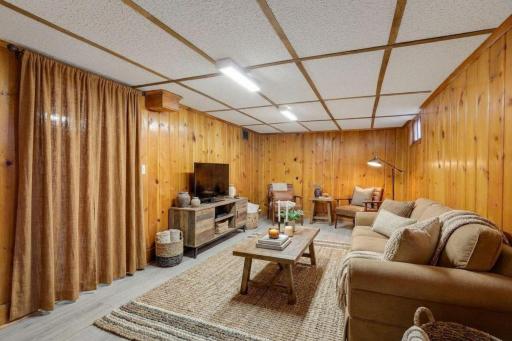 Virtually stage family room in lowest level.