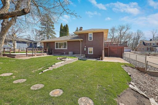 Rear yard with deck, patio and firepit. Also access to double garage.