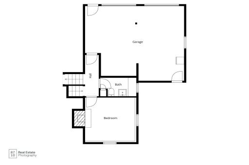 Lower level bedroom/den area with bath and garage access.
