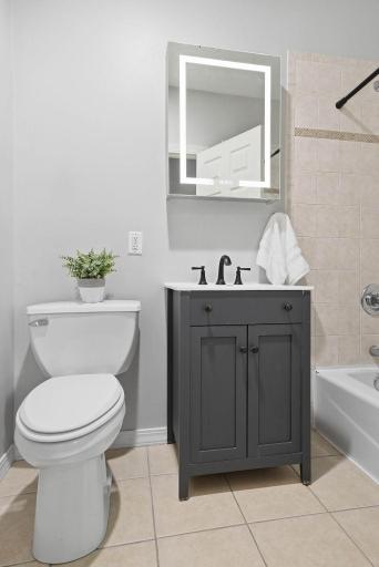 Freshly updated bathroom with tiled shower and modern finishes.