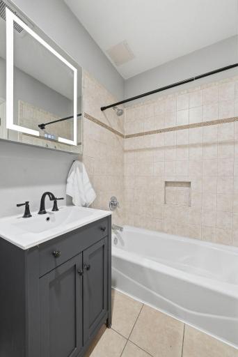 Full bathroom featuring clean lines, neutral tones, and updated fixtures.