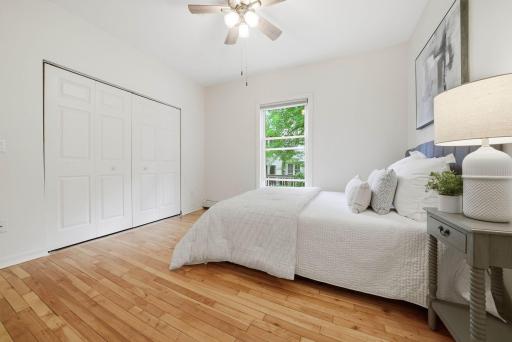 Bright primary bedroom with large windows and abundant natural light in the heart of Linden Hills.