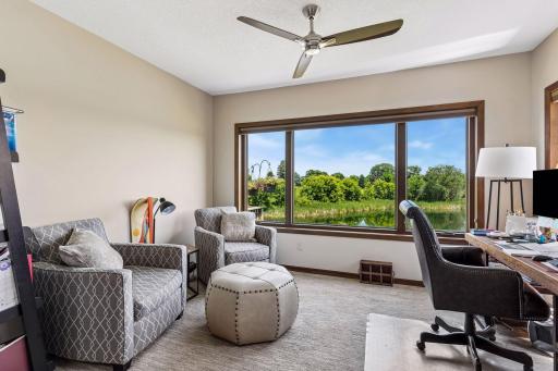 Beautiful space for an office or a seating area, or seen here, BOTH! Plenty of space to add your desired seating arrangements. This room is filled with the natural light and golf-course views.