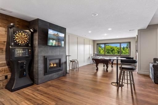 They invested over $180,000 in the lower-level renovation. There is a custom wet bar, beverage refrigerator, pizza oven, new fireplace, new carpet, updated ceiling, custom millwork, new flooring, and two large wine cabinets wine coolers.